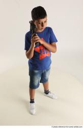 TIMBO STANDING POSE WITH GUN